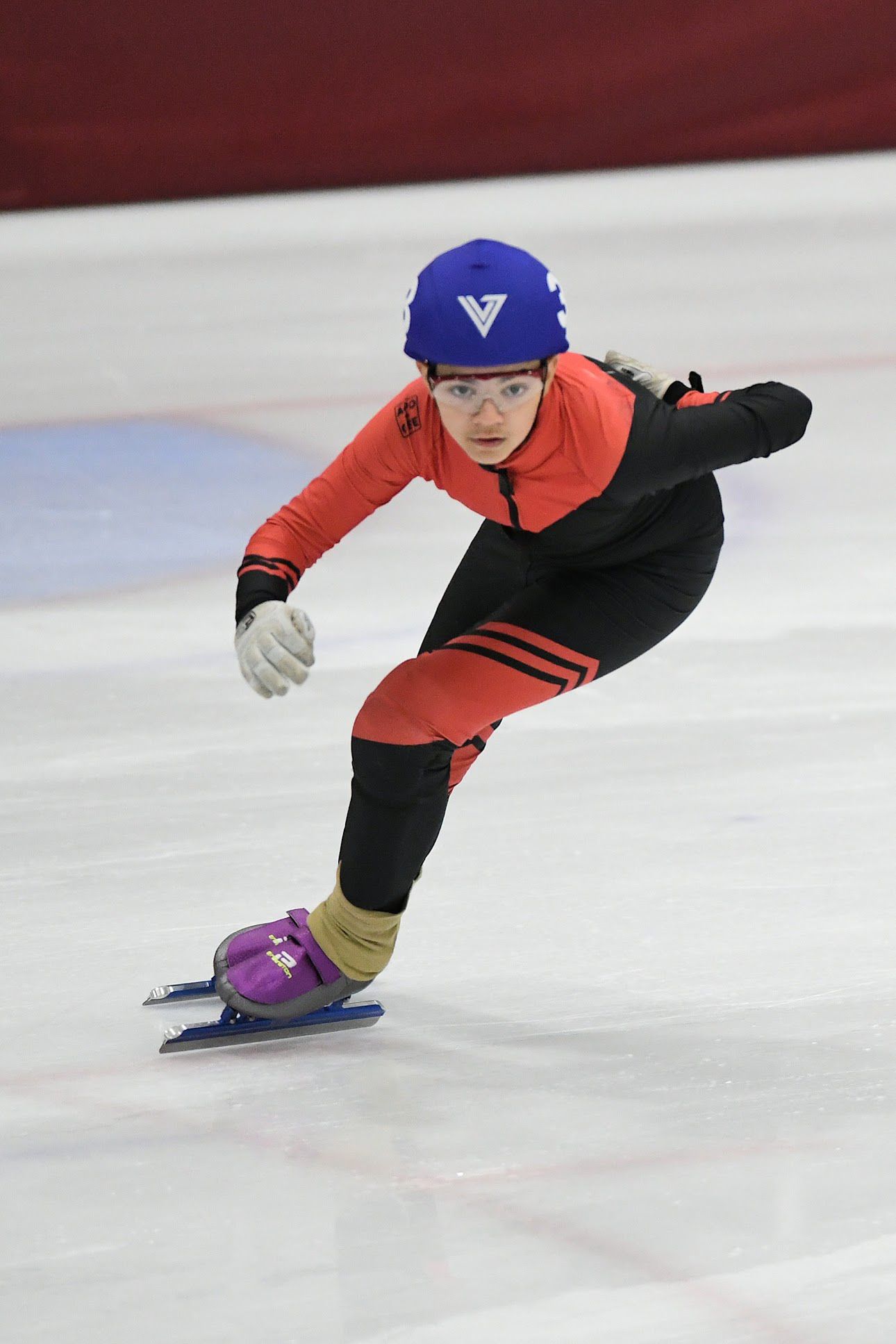 Burnaby skater in red and black skinsuit